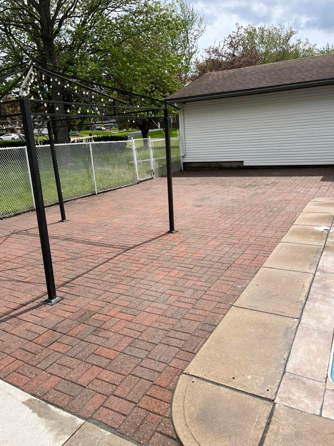 Large brick-paved driveway and patio area