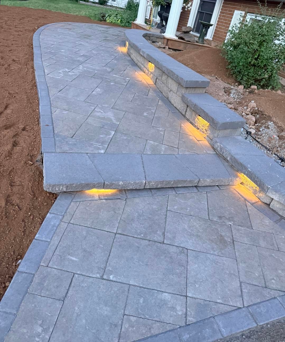 Finished front walkway made from large grey pavers