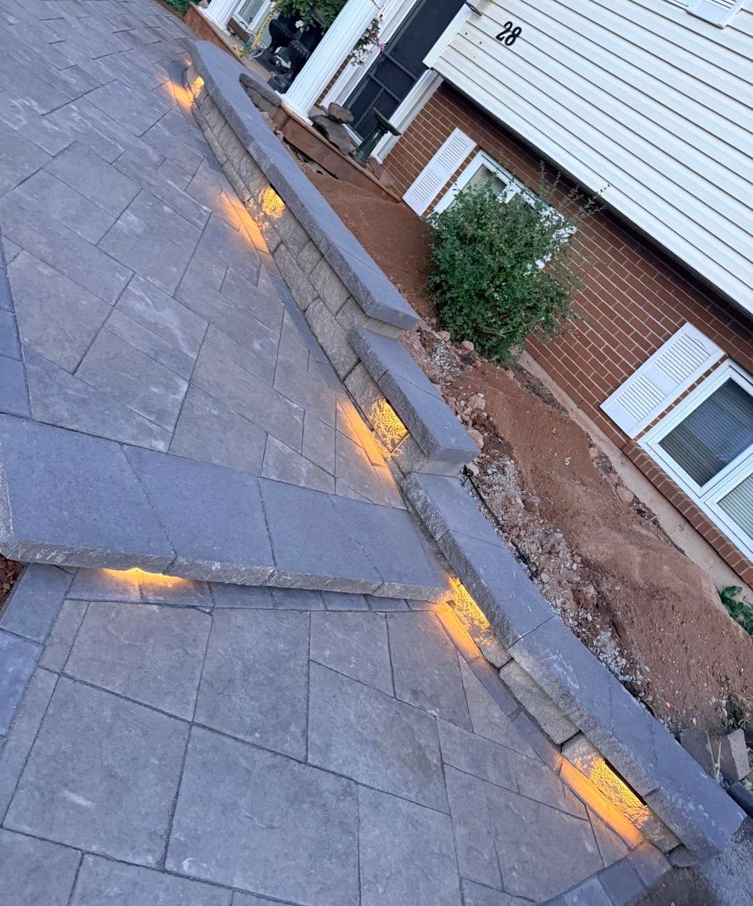 Front paver walkway with integrated step lights