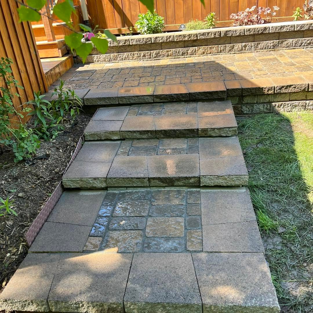 Rebuilt paver steps leading into a garden